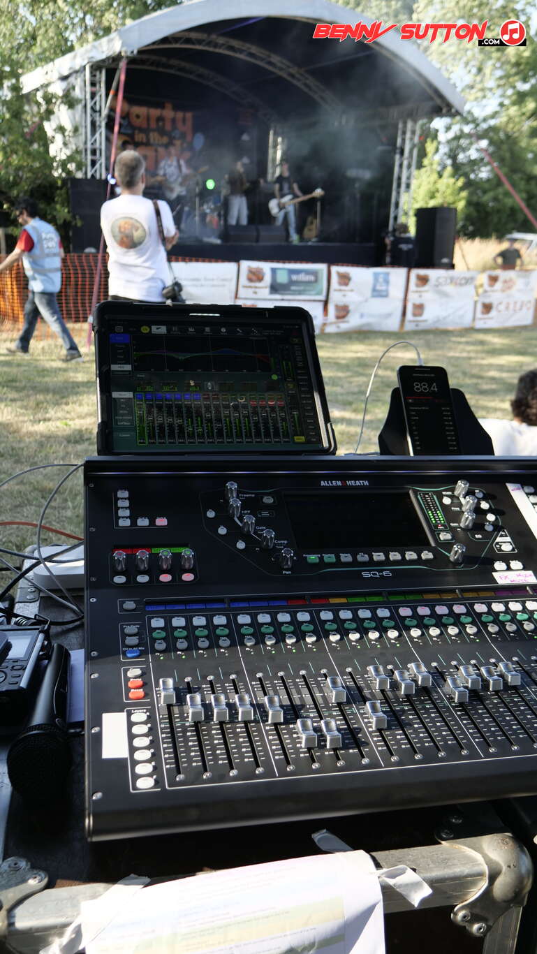Sound engineer mixing desk at small festival